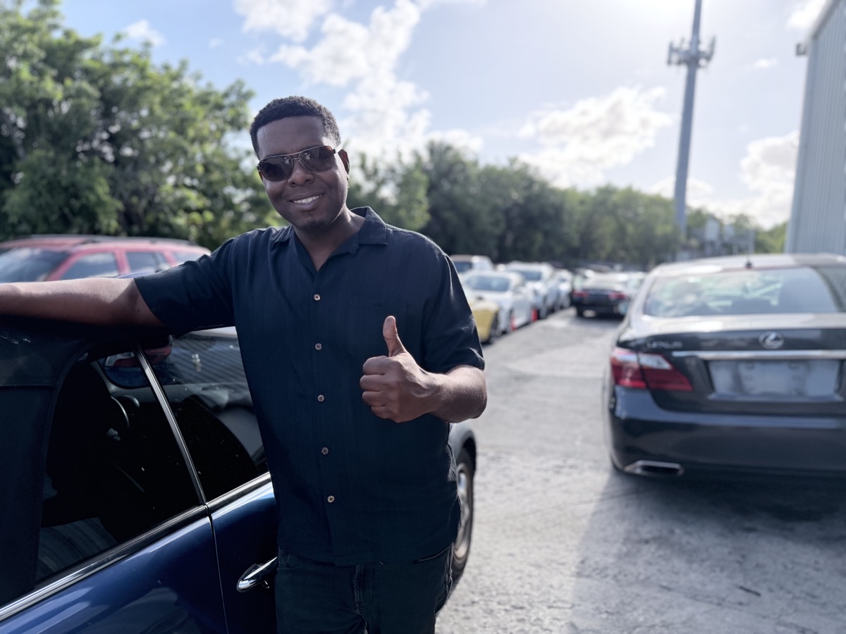 Omari Grant, owner of Fort Lauderdale Auto Sales, standing on the lot